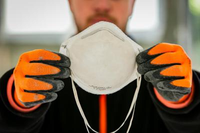 Arbeiter hält Maske Arbeiter hält Maske
